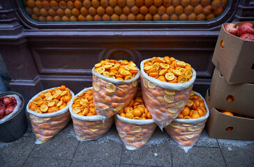 garbage bags with orange peels after squeezing them
selective focus