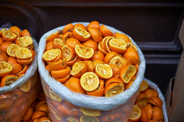 garbage bags with orange peels after squeezing them
selective focus