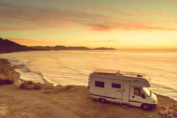 Caravan on sea coast at sunrise. Aerial view