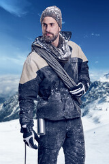 Mountain, man and thinking on summit with snow for adventure, exercise or climbing gear in...