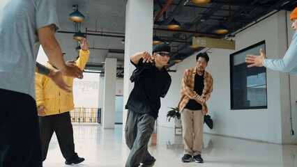 Hipster perform break dancing while partner dancing together at corridor, modern mall. Hip-hop...