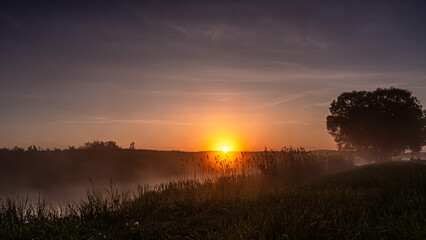 Sunrise over the Suprasl River at the boulevard in Suprasl.