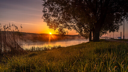 Sunrise over the Suprasl River at the boulevard in Suprasl.