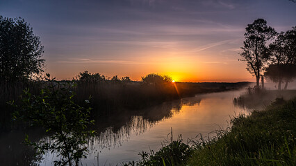 Sunrise over the Suprasl River at the boulevard in Suprasl.