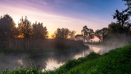 Sunrise over the Suprasl River at the boulevard in Suprasl.