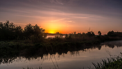 Sunrise over the Suprasl River at the boulevard in Suprasl.