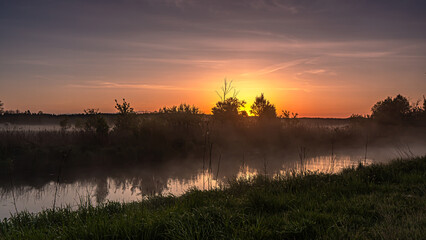 Sunrise over the Suprasl River at the boulevard in Suprasl.