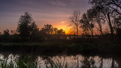 Sunrise over the Suprasl River at the boulevard in Suprasl.