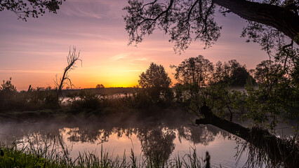 Sunrise over the Suprasl River at the boulevard in Suprasl.