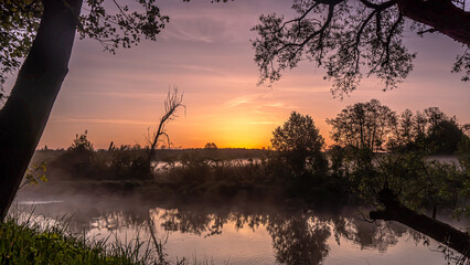 Sunrise over the Suprasl River at the boulevard in Suprasl.