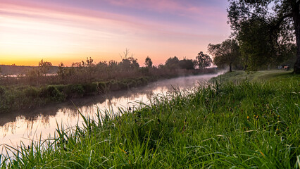 Sunrise over the Suprasl River at the boulevard in Suprasl.