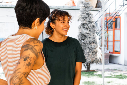 Smiling Women Engaging in Conversation Outdoors