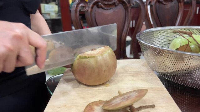 Chrysophyllum cainito Also known cainito, caimito, tar apple, star apple, purple star apple, golden leaf tree, abiaba, pomme de lait Golden leaf tree. Star apple fruits