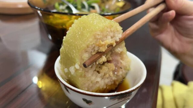 Dipping New Year's rice cake in sauce honey sauce sweet celebration food on the table peas in lipsey Zongzi. Rice dumpling for Chinese traditional Dragon Boat Festival