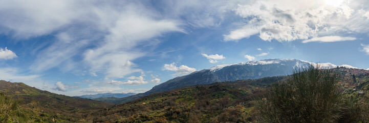 Panoramic view of valley and the high mountains of the Madonie Nature Park with town of Isnello on a sunny day, Isnello, Sicily, Italy