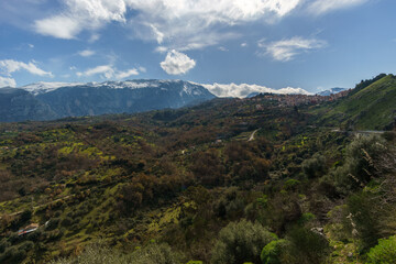 Fototapeta premium View of valley and the high mountains of the Madonie Nature Park with town of Isnello on a sunny day, Isnello, Sicily, Italy