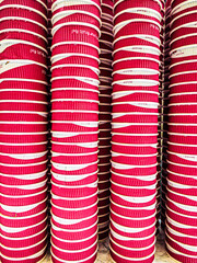 Red, paper soda cups stacked up on a worktop