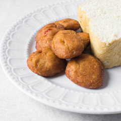 Akara and bread on a white plate, nigerian akara fried beans cake and bread on a plate