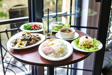 Wooden Table With Assorted Plates of Food