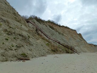 old ruined staircase for descending from the sandy mountain