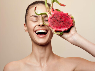Woman holding a watermelon slice in front of her face with eyes closed in a serene moment
