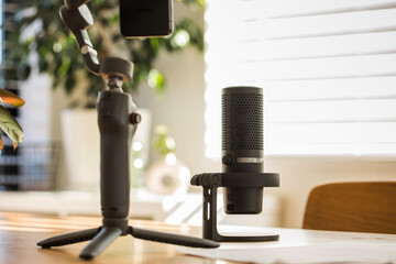 Podcast microphone setup on a wooden desk. The concept of recording a podcast, streamer