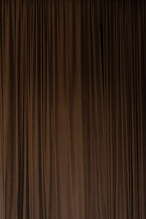 Dark brown chocolate curtain that dropped down as a straight line. Background for inserting text,...