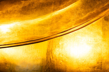 Gold Background. Wall pasted with golden tiles in a Thai temple.
