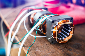 Copper windings inside an electric motor. The mechanic is repairing an electric motor by replacing...