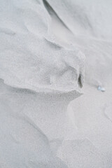 Dune Sand Ripple Closeup Texture in Cold Winter Morning Sunlight with Shallow Depth of Field
