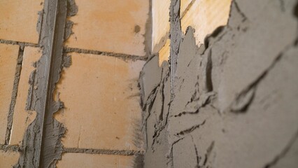 A worker applies putty to the wall. A plasterer applies plaster to a wall. Applying plaster to the...