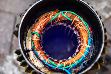 Copper windings inside an electric motor. The mechanic is repairing an electric motor by replacing...