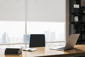 Modern office with a laptop on a desk, cityscape in the background, concept of work environment. 3D Rendering