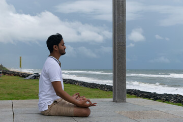 A person practicing yoga at beach. International Yoga day breathe peace calm mindful body relax mental physical, workout, jogging running enjoy breeze morning sunrise Vitamin D fitness fresh BeH3althy