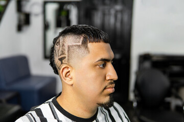 Stylish Man with Creative Haircut in Barbershop