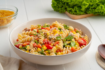 Homemade macaroni salad with trivelle pasta and canned tuna, carrot, Head Lettuce, tomato, corn and...