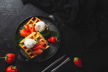 Belgian waffles with strawberries and ice cream