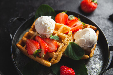 Belgian waffles with strawberries and ice cream