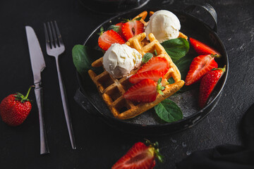Belgian waffles with strawberries and ice cream