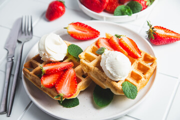 Belgian waffles with strawberries and ice cream