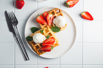 Belgian waffles with strawberries and ice cream