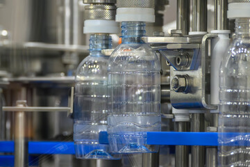The  empty drinking water bottles  on the conveyor belt for filling process.