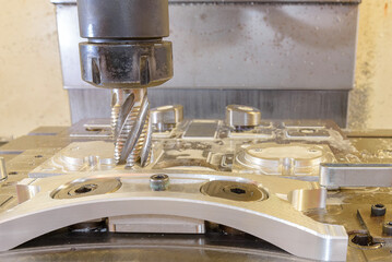 The CNC milling machine cutting  aluminum automotive part by rough cutter.