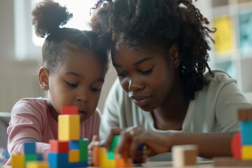 Obraz premium A woman and child having fun playing with colorful blocks. Ideal for educational and family-related designs