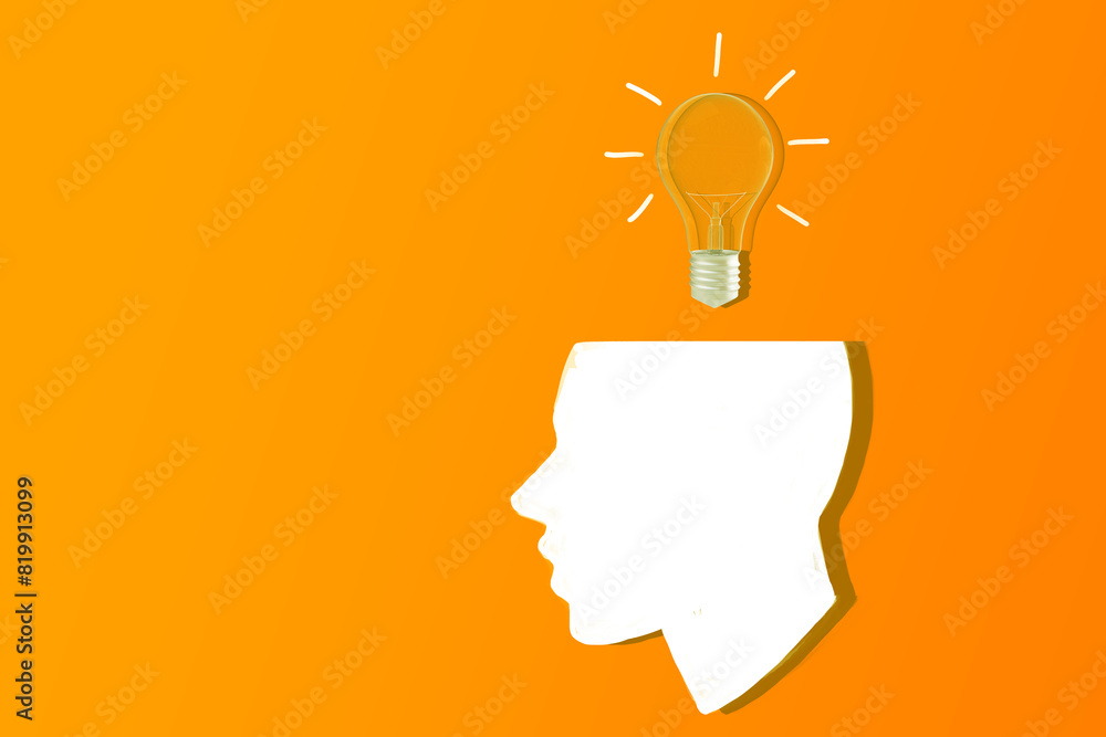 Poster a silhouette of a human head with a light bulb overhead on an orange background, concept of idea and