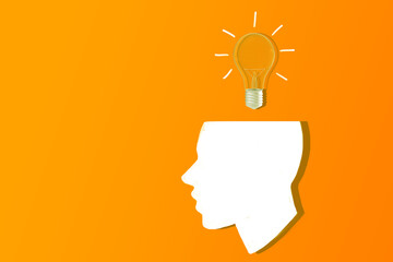 A silhouette of a human head with a light bulb overhead on an orange background, concept of idea and creativity. 3D Rendering