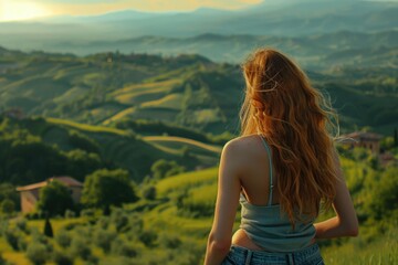 A woman standing on top of a beautiful green hillside. Perfect for nature and outdoor themes