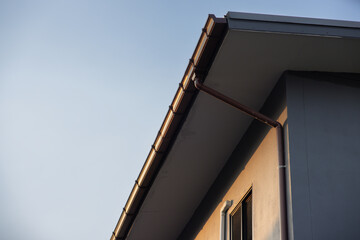 A roof with a gutter and a pipe