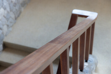 A wooden railing with a stone floor