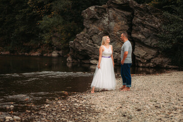 Couple in love standing by the river. Copy space